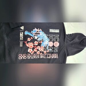 Black beanie sweater with pink and blue lettering on the back